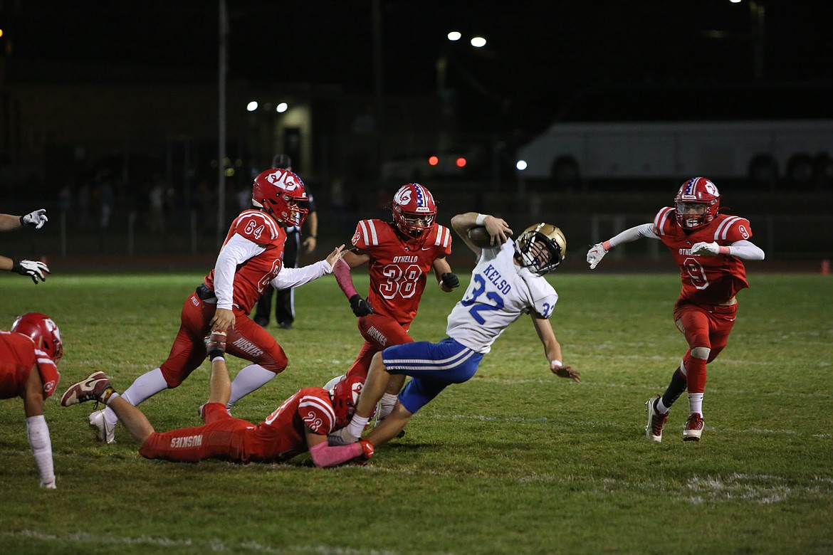 Othello defenders swarm to the ball during a game against Kelso. The Huskies ended the season 7-3, co-CWAC champions with Ephrata and qualified for the 2A playoffs where they lost 49-12 to Enumclaw