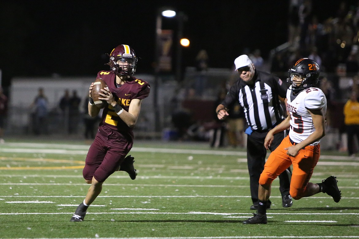 Moses Lake sophomore Brady Jay, left, scrambles with the football during a game against Davis. The Mavericks ended the season with an 8-2 record and in second place of the Columbia Basin Big 9.