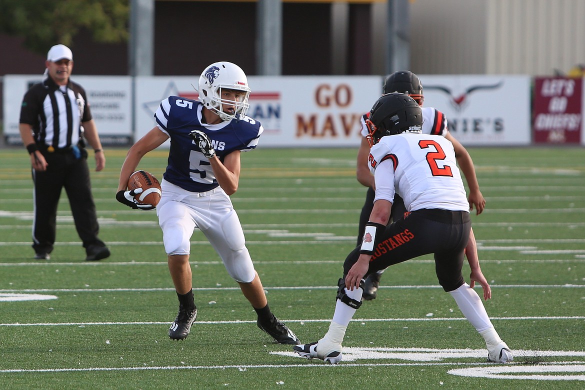 MLCA/CCS sophomore Jonny Ferguson (5) looks to shake off a Bridgeport defender. The Lions went 7-2 in their inaugural season this fall, falling to the eventual 1B state champion Liberty Bell in their crossover game.