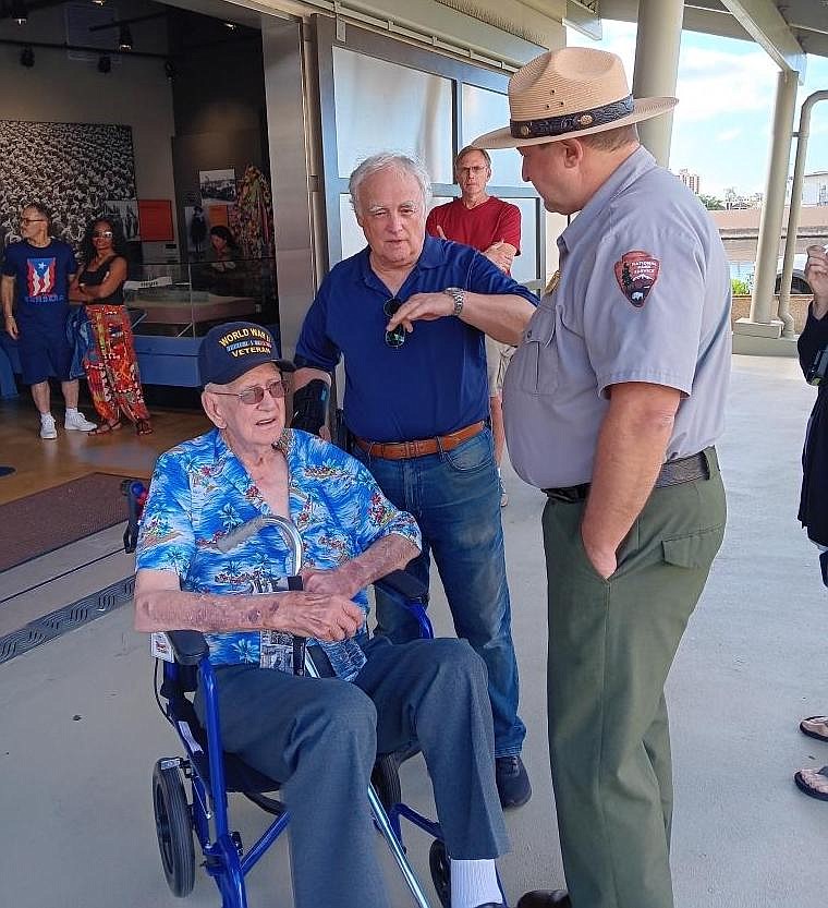 World War II veteran and Pearl Harbor survivor Ed Carroll, 99, of Salt Lake City, seated, is seen Monday at the Pearl Harbor National Memorial. Today marks 82 years since the Japanese attack that thrust the U.S. into World War II.