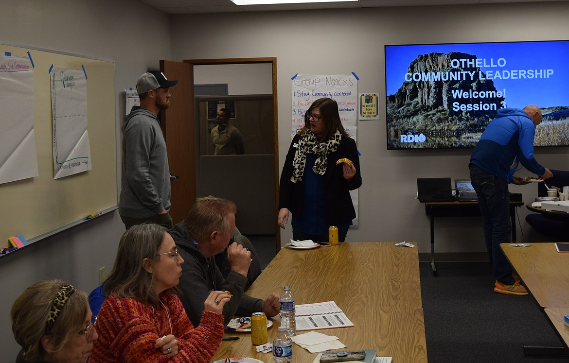 Rural Development Initiatives Leadership Services Business Manager and Rural Community Leadership Program Lead Trainer Christine Gilmore, standing right, speaks to Adams County Development Council Executive Director Kyle Niehenke, standing left, prior to the program’s Nov. 30 session.