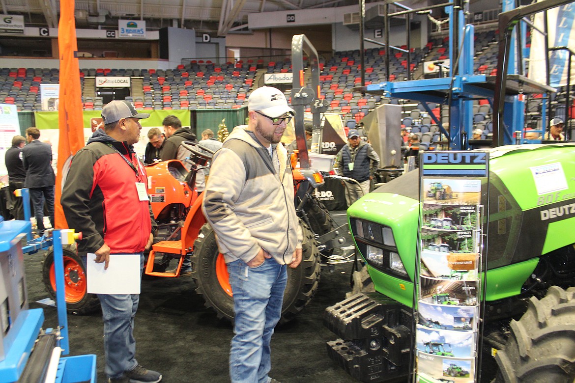 Attendees at Tuesday’s session of the Washington Horticultural Association annual meeting look over the newest in farm equipment.