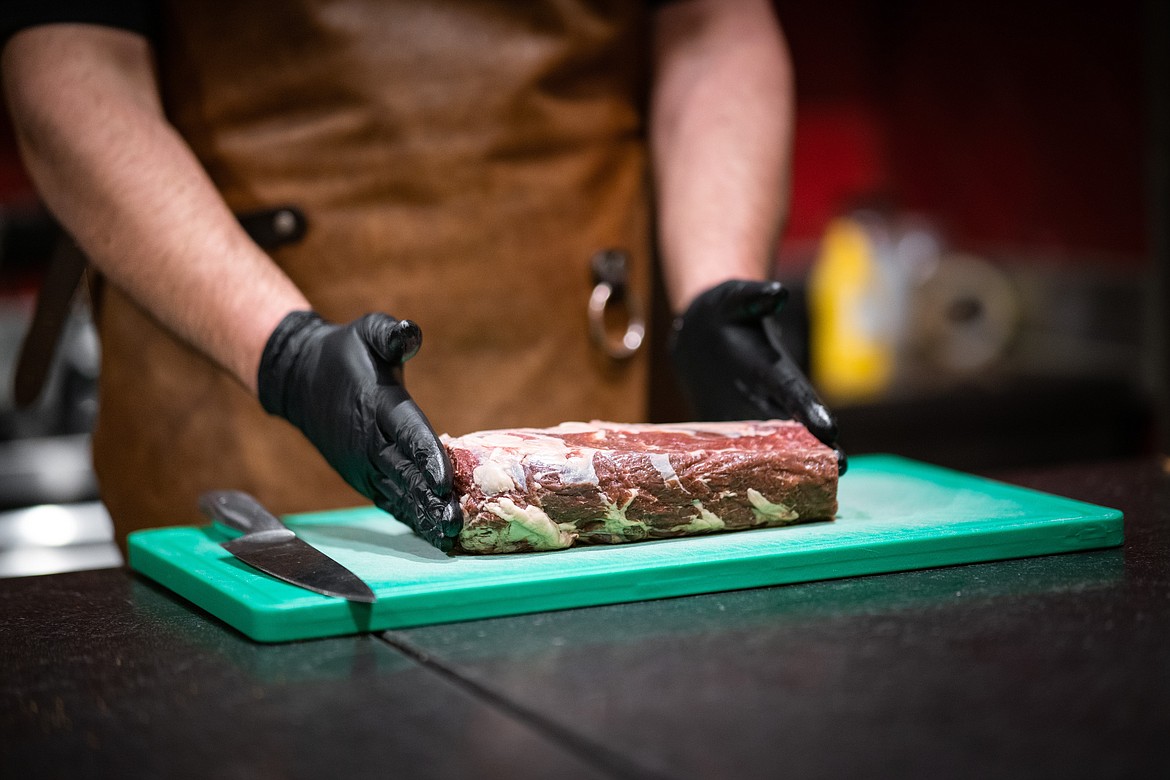 A butcher prepares wild game meat.