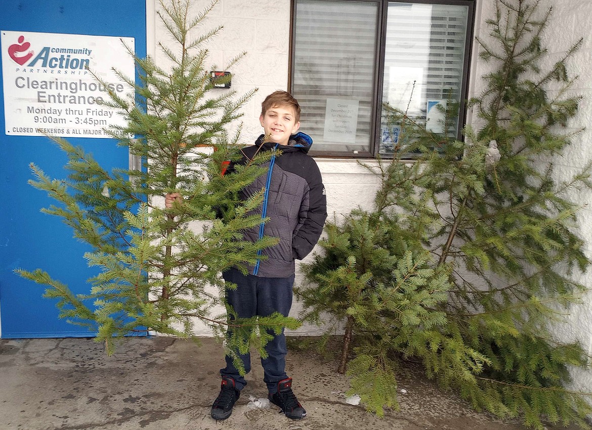 Gabriel Beaman delivers a tree to the Community Action Partnership food bank.