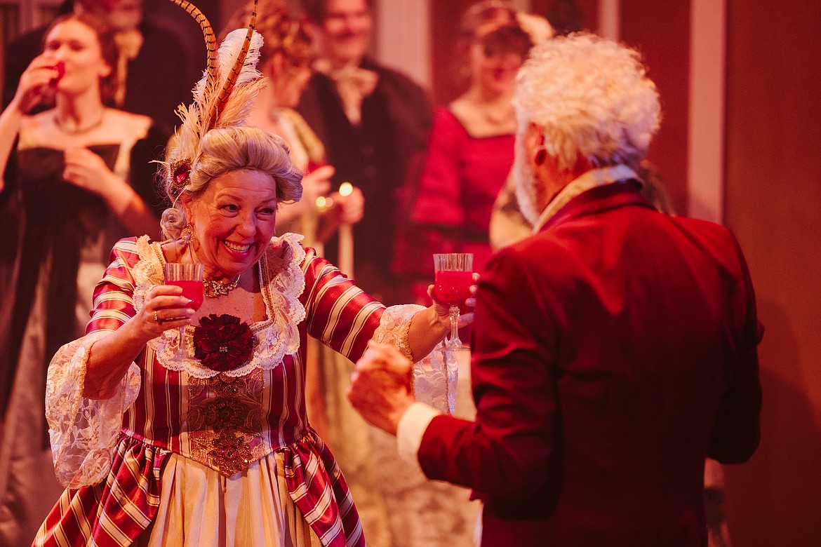 Dianne Guenther hands Tony Hernandez a drink during a dress rehearsal for the Whitefish Theatre Company's 2023 production of "A Christmas Carol." The pair play Mr. and Mrs. Fezziwig in the musical. (Photo courtesy of Matt Wetzler/Thewmatt Photography)