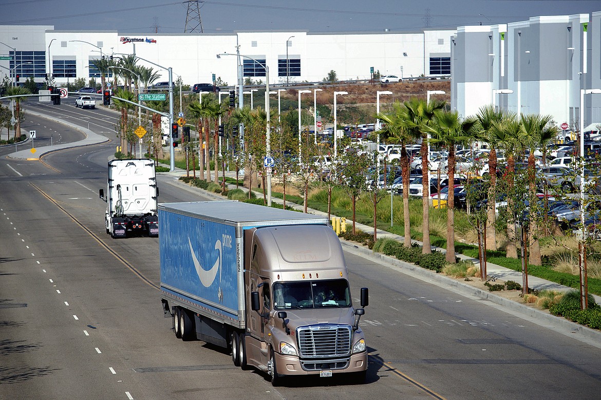 A semi-truck turns into an Amazon Fulfillment center in Eastvale, Calif. on Thursday, Nov. 12, 2020. An internal Amazon memo has provided a stark look at the company’s carefully laid out plans to grow its influence in Southern California through a plethora of efforts that include burnishing its reputation through charity work and pushing back against “labor agitation” from the Teamsters and other groups. (Watchara Phomicinda/The Orange County Register via AP, File)