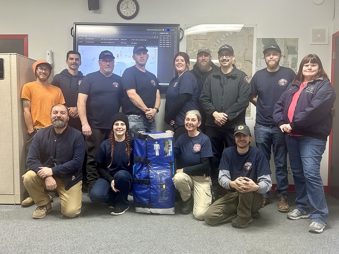 Grant County Fire District 7 staff stop for a photo with the ZOLL AutoPulse Resuscitation System the department recently purchased. The new system will improve the quality of care they are able to provide to patients when they arrive at a scene.