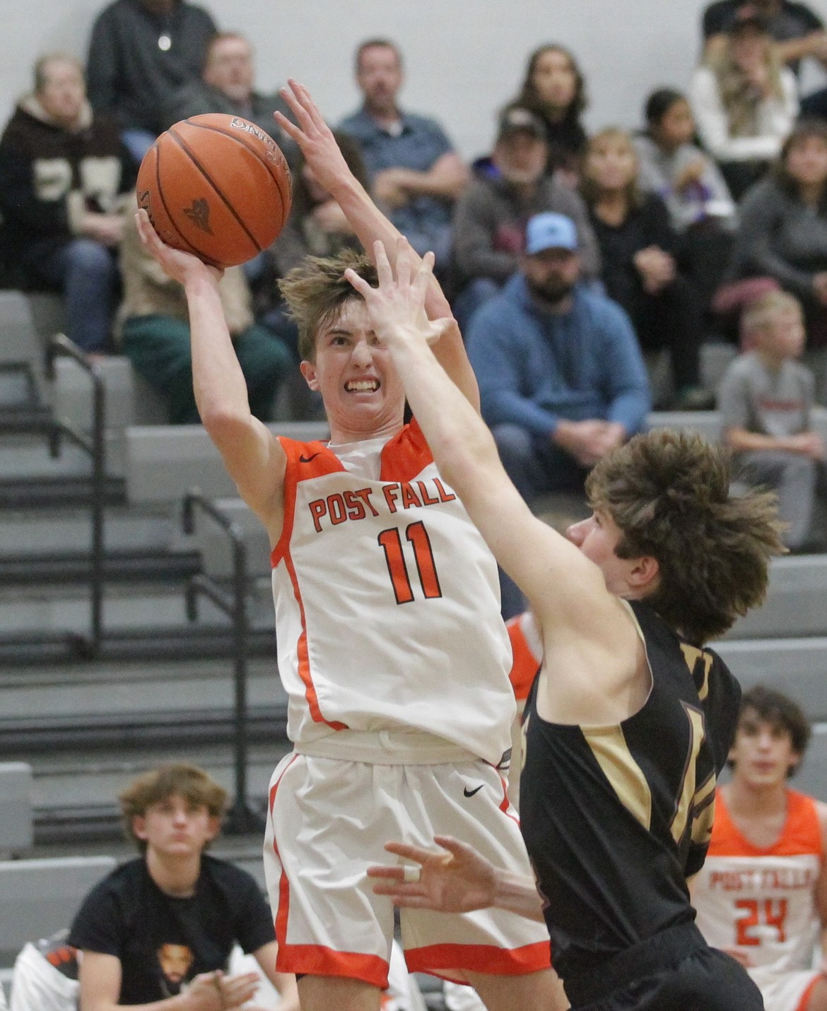 MARK NELKE/Press
Post Falls junior Cobe Cameron (11) puts up a shot as Luke Gisolo of University defends on Thursday night at The Arena at Post Falls.