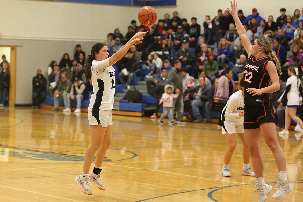 Warden senior Aliza Leinweber, left, attempts a three-pointer against Cashmere on Nov. 28.