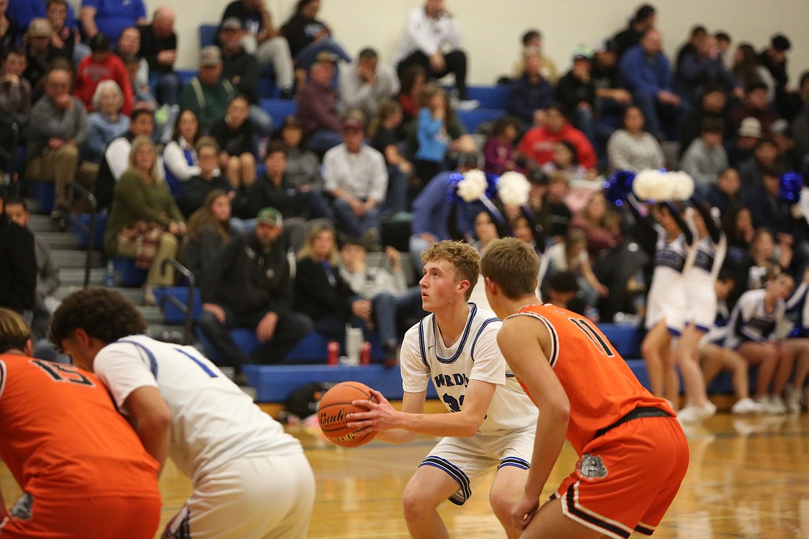 Warden junior Jake Roylance, in white, attempts a free throw against Cashmere on Nov. 28.