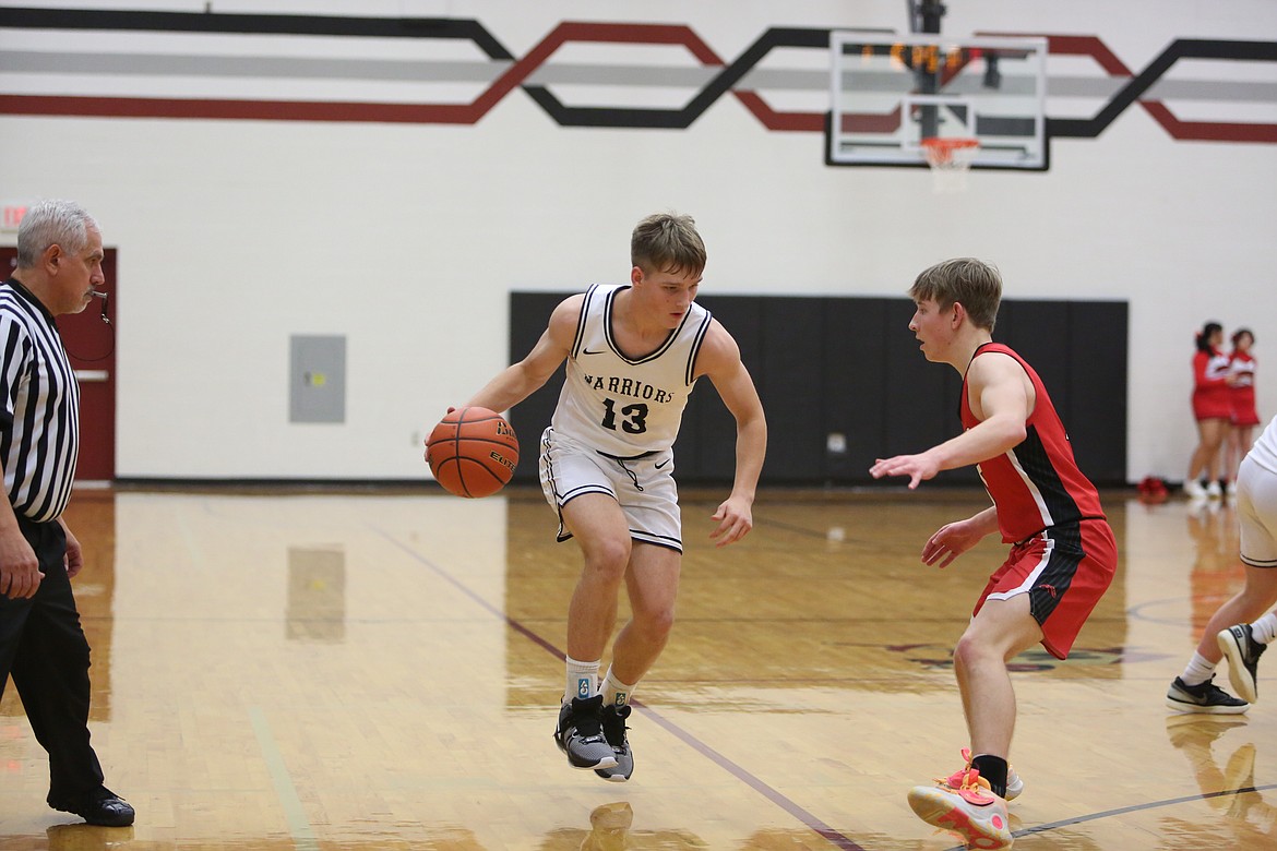 Almira/Coulee-Hartline sophomore Josh Booker (13) brings the ball up the floor against Lind-Ritzville/Sprague on Saturday.