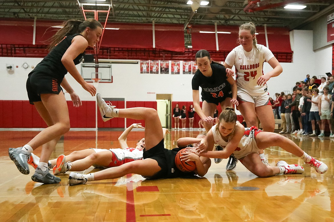 Sandpoint freshman Jordyn Tomco battles for possession of the ball against Post Falls' Brooklyn Brennan while Aliya Strock (left) and Karlie Banks are in support nearby.