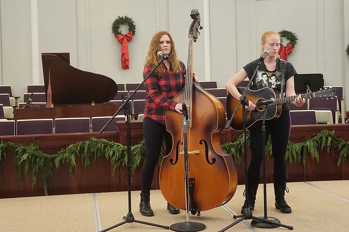 Kenda and Meghan Walker of Redhead Express take part in a soundcheck during a dress rehearsal Wednesday. The pair are among the local artists taking part in "When We Seek Him", a Christ-centered Christmas concert. The concert is Sunday at 6:30 p.m. at the Church of Jesus Christ of Latter-day Saints.