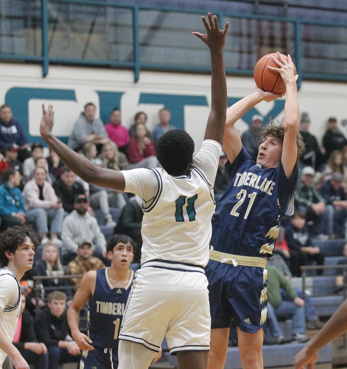 MARK NELKE/Press
Timberlake senior Cole Meidinger (21) shoots over Lake City sophomore Josh Watson (11) on Friday night at Lake City High.