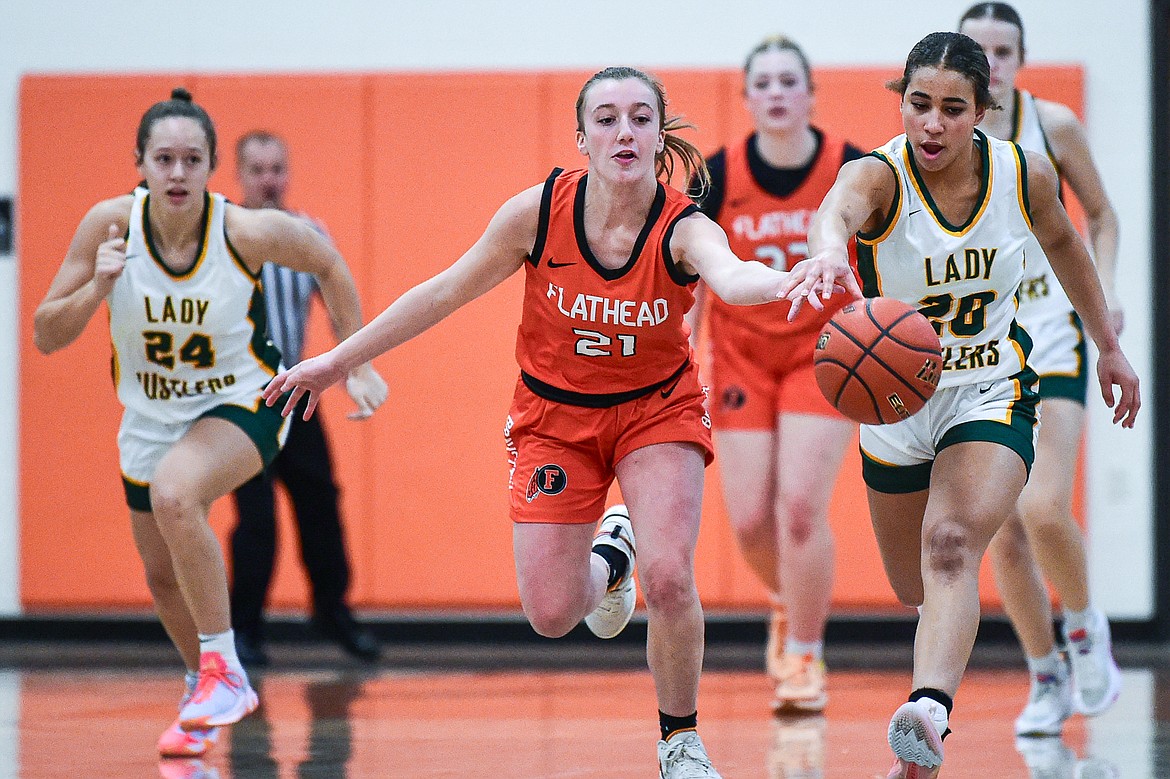 Flathead's Harlie Roth (21) chases down a loose ball against Great Falls CMR's Rhema Pace (20) at Gene Boyle Gym on Saturday, Dec. 9. (Casey Kreider/Daily Inter Lake)