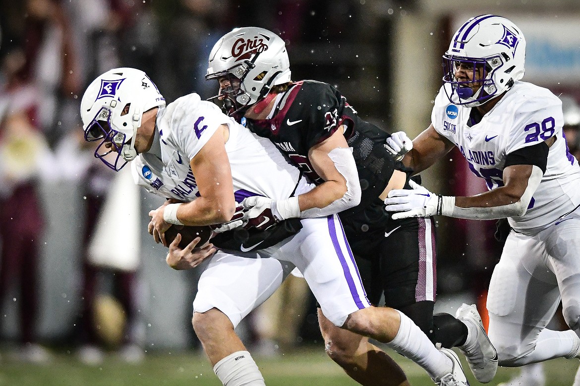 Grizzlies linebacker Riley Wilson (42) sacks Furman quarterback Tyler Huff (6) in the second quarter of an FCS Playoff game against Furman at Washington-Grizzly Stadium on Friday, Dec. 8. (Casey Kreider/Daily Inter Lake)