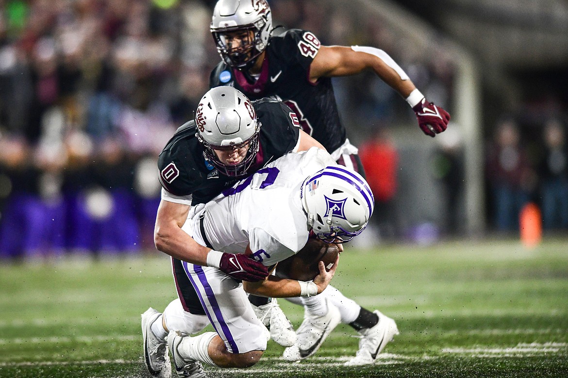 Grizzlies defensive end Kale Edwards (0) sacks Furman quarterback Tyler Huff (6) in the first quarter of an FCS Playoff game at Washington-Grizzly Stadium on Friday, Dec. 8. (Casey Kreider/Daily Inter Lake)