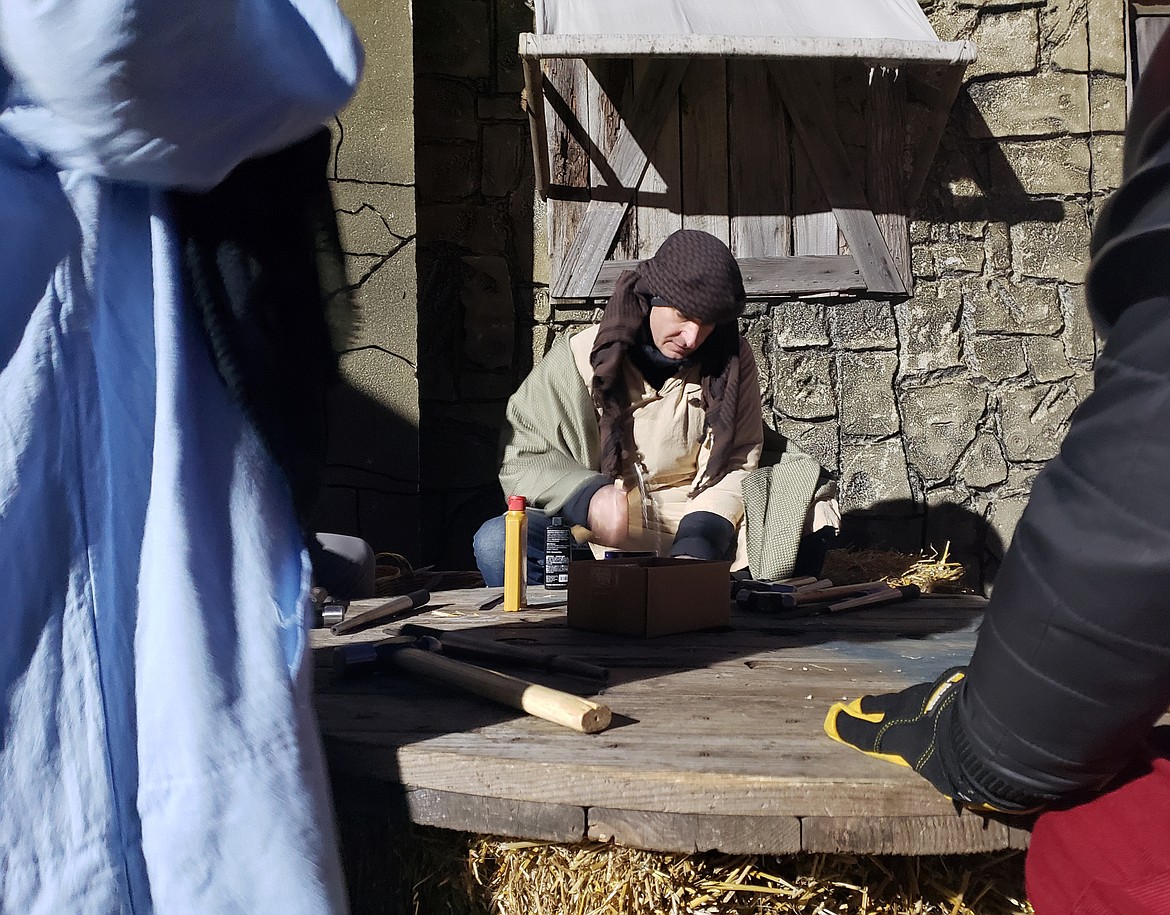 Ryan Fobes volunteers at the Night at Bethlehem and teaches kids to hammer rings.