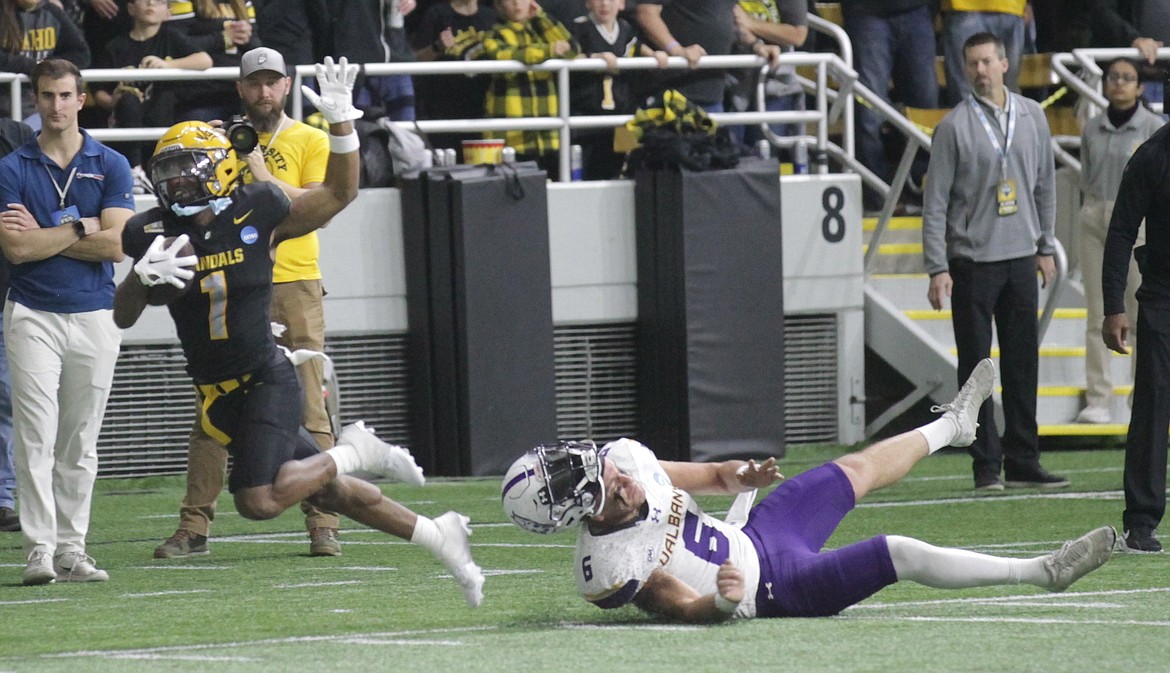 MARK NELKE/Press
Jermaine Jackson (1) of Idaho returns a second-quarter punt 73 yards to the UAlbany 14 as punter Tyler Pastula (6) of the Great Danes pursues Saturday night in an FCS quarterfinal game at the Kibbie Dome in Moscow.