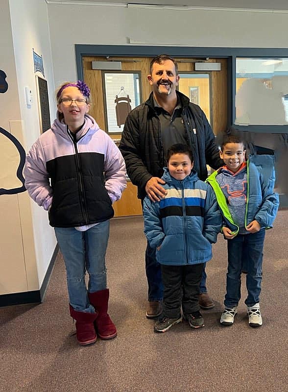 Moses Lake Fire Department Lieutenant Jason Koziol with students from Peninsula Elementary School during this year’s coat distribution in association with Operation Warm.