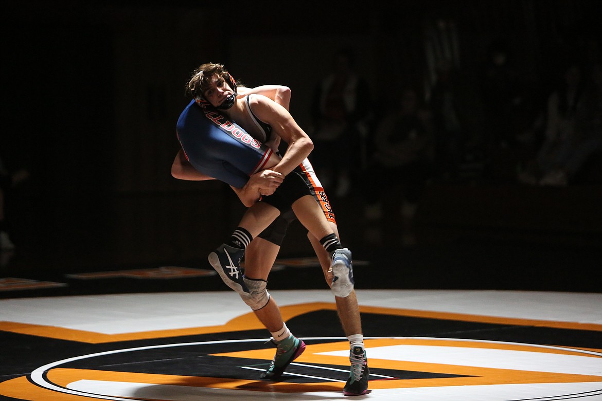 Ephrata senior Zander Boyd, background, takes down his opponent at the Tiger’s dual against Ellensburg on Thursday.