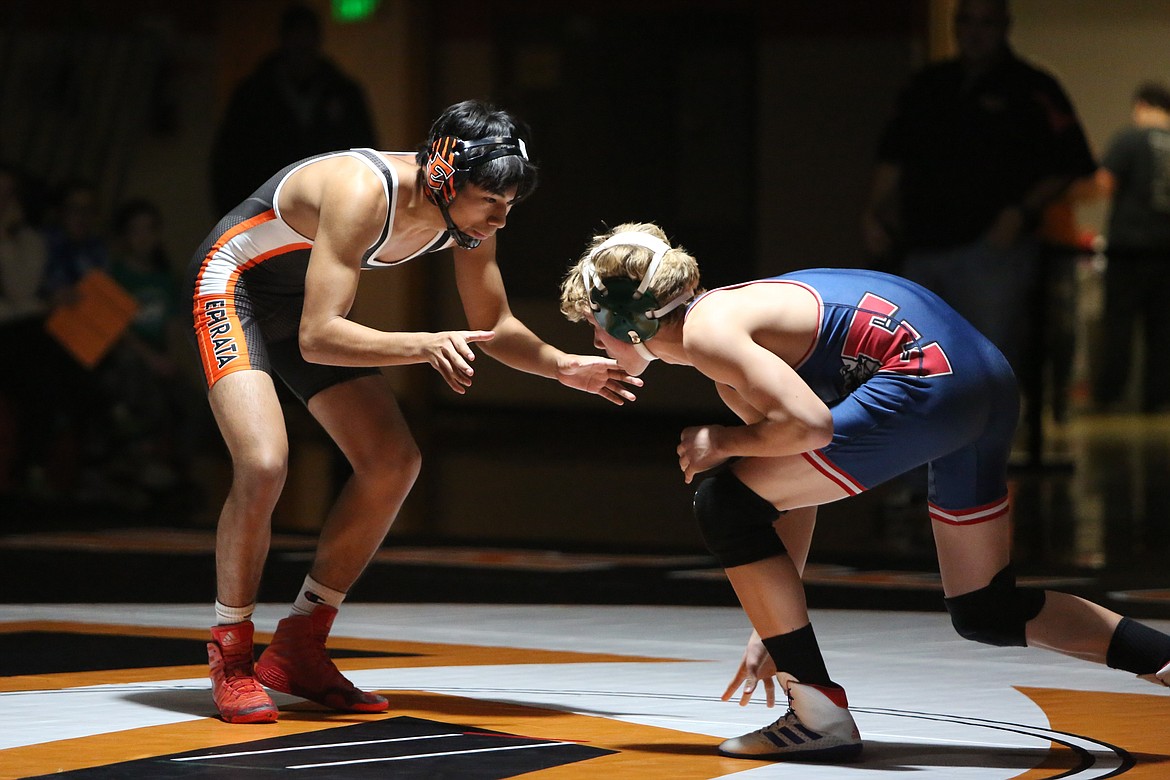 Ephrata senior Zander Boyd, background, takes down his opponent at the Tiger’s dual against Ellensburg on Thursday.