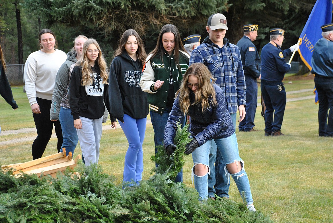 Students and advisors from the National Honor Society of St. Regis High School paid tribute to those lost in the attack on Pearl Harbor by crafting wreaths, and placing them on stands at the local cemetery. This took place while the American Legion Montana Ray Welch Post 13 color guard displayed the flags and played taps. (Mineral Independent/Amy Quinlivan)