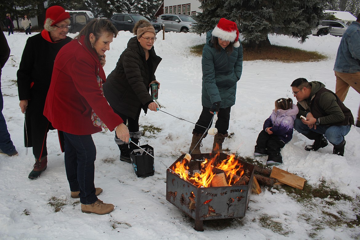 Roasting marshmallows was organized for the kids, but as soon as they were done, adults jumped in. (Monte Turner/Mineral Independent)