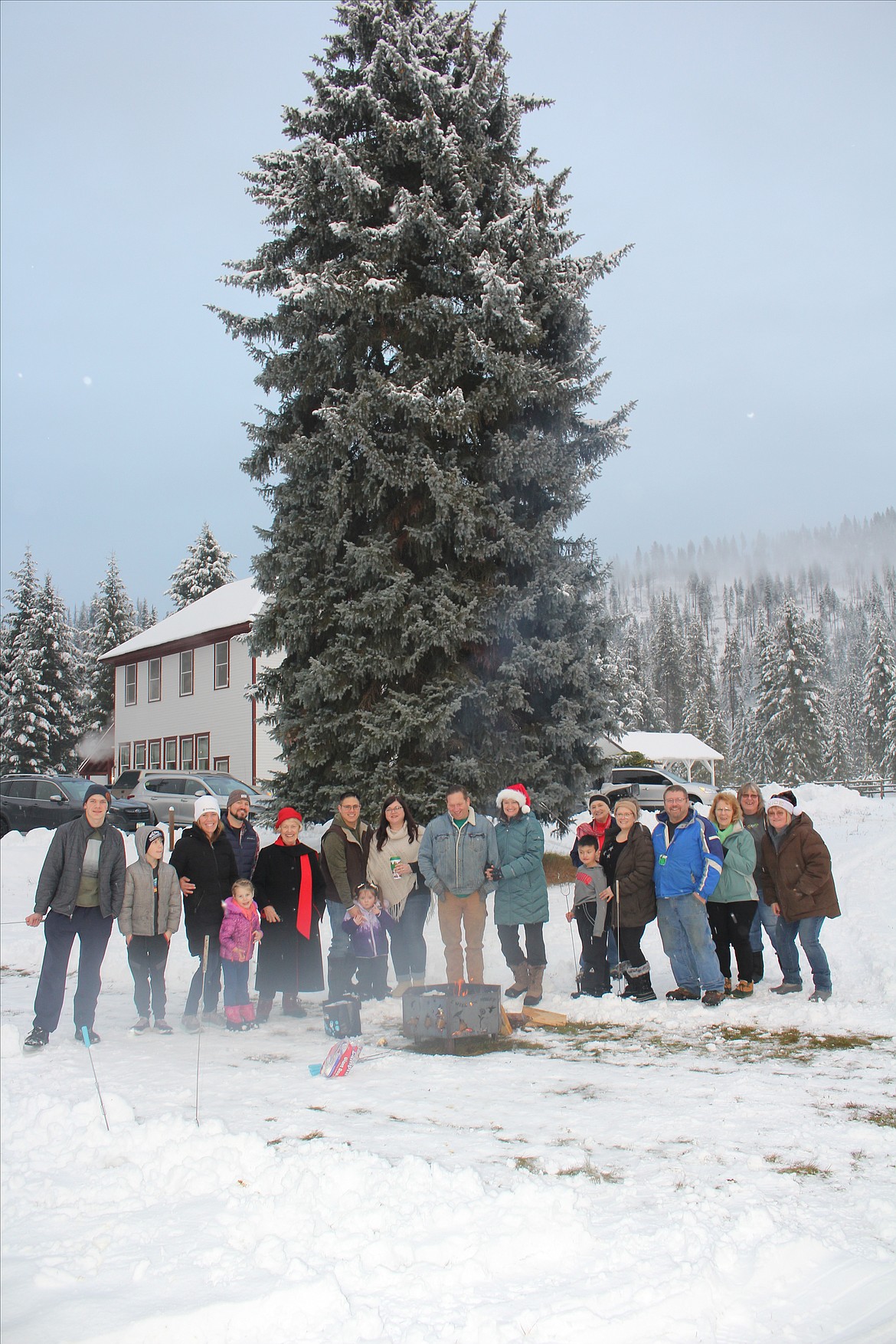 Standing in front of the ‘Cooper Tree’, west end residents and family visitors roasted marshmallows to ring in the Christmas season as the bell in the school rang at 5 p.m. Sunday.