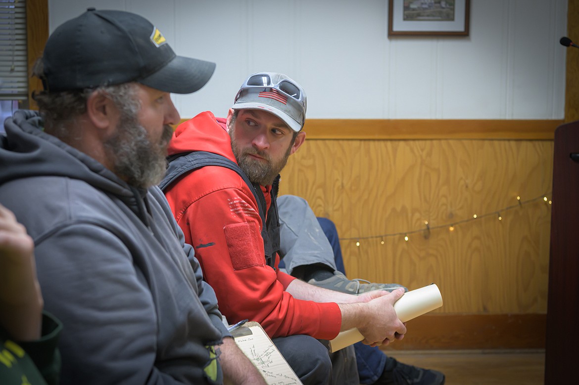 Harvest Church proponent Aaron Garland discusses flood plain boundries with surveyor Ron Warren.