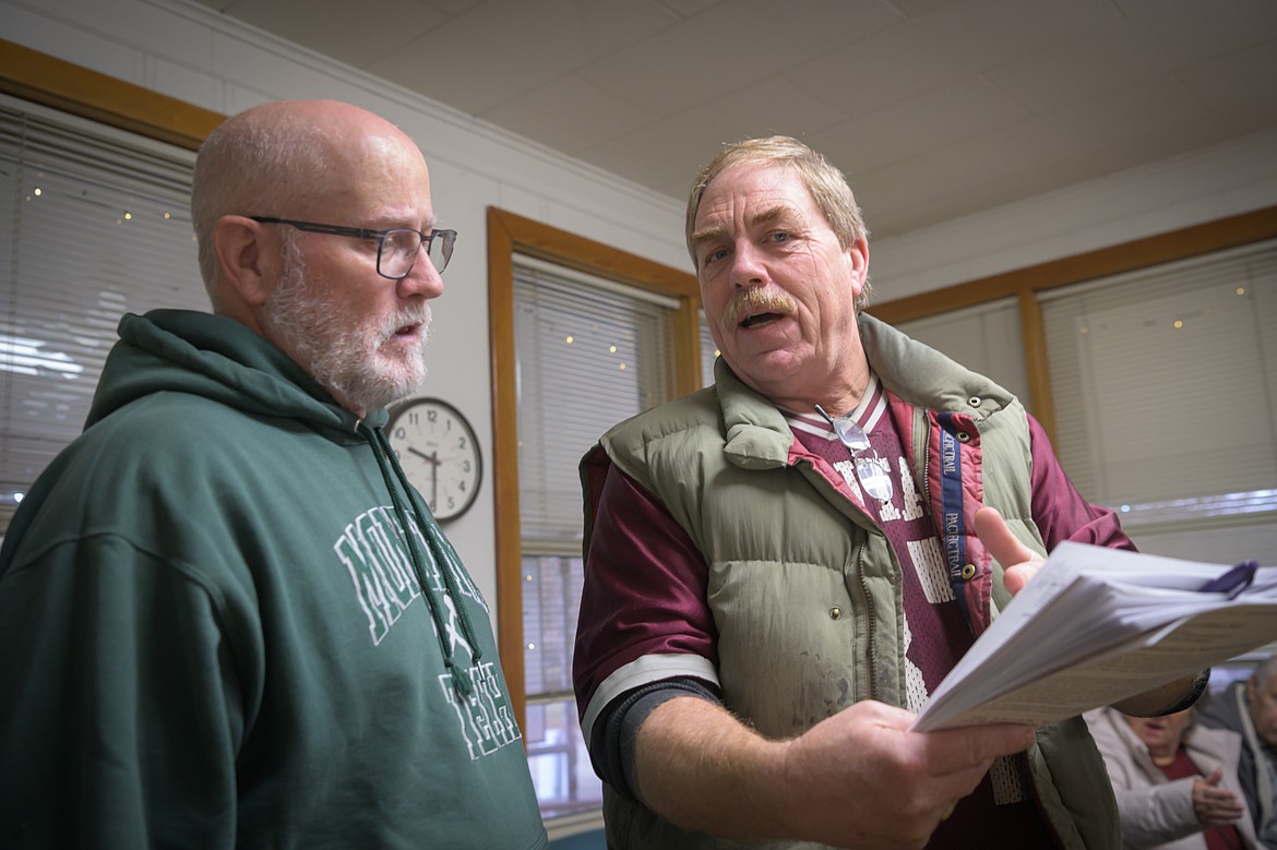 DNRC civil engineer Larry Schock and local surveyor Ronald Warren discuss Harvest Church's flood plain locations. (Tracy Scott/Valley Press)