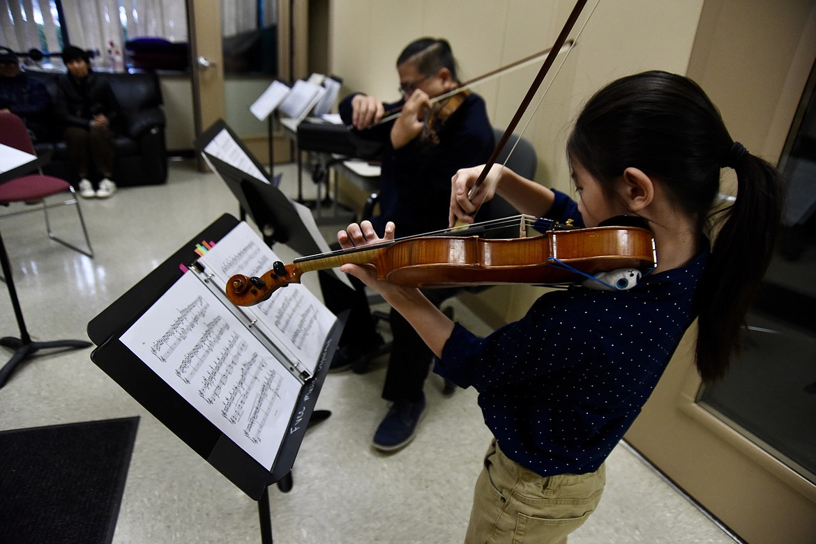 ZIAO CHEN, 9, rehearses with instructor and performer, Wai Mizutani, at Flathead Valley Community College on Nov. 6, 2023. The pair will perform a Christmas concert together along with Ziao’s father, Xiao Long Chen, brother, Zichong, 16, and pianist Clementa Cazan German, at the Wachholz College Center at 7 p.m. Dec. 16. (Hilary Matheson/Daily Inter Lake)