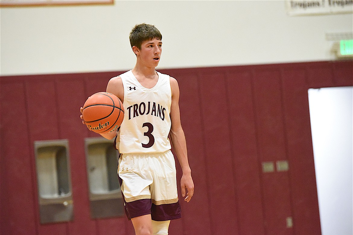 Troy's Carson Orr brings the ball up court against St. Regis in a game on Saturday, Dec. 9. (Scott Shindledecker/The Western News)