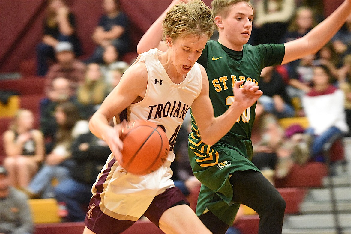 Troy's Cody Todd works to get into the lane on Saturday, Dec. 9, against St. Regis. (Scott Shindledecker/The Western News)