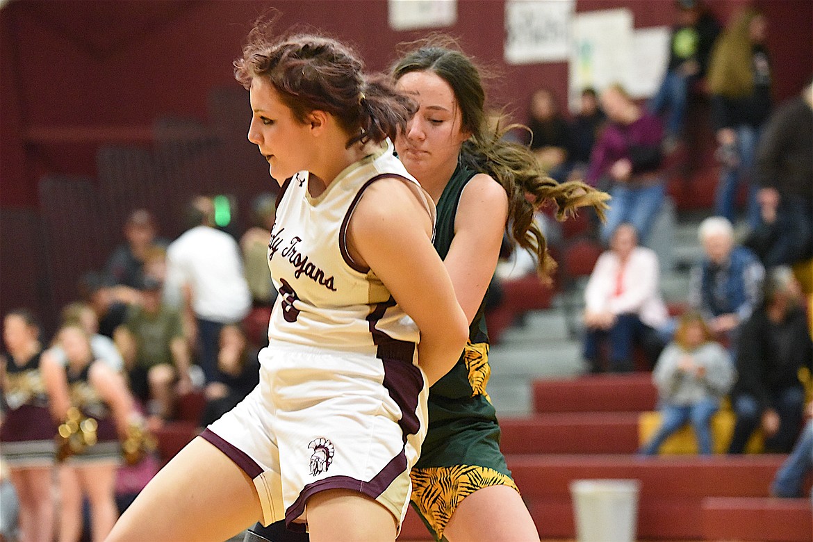 Troy's Hailey Dungan battles for the ball with a St. Regis player on Saturday, Dec. 9, against St. Regis. (Scott Shindledecker/The Western News)