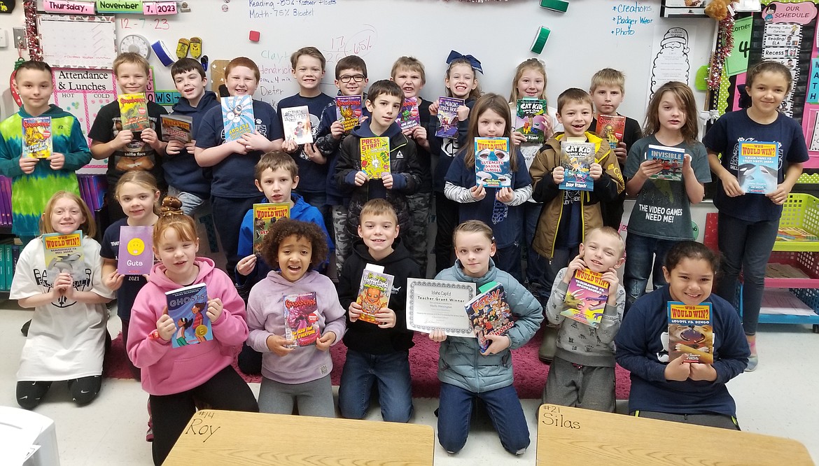 Shelly Hoisington's third grade class receives books for their classroom library thanks to a grant.