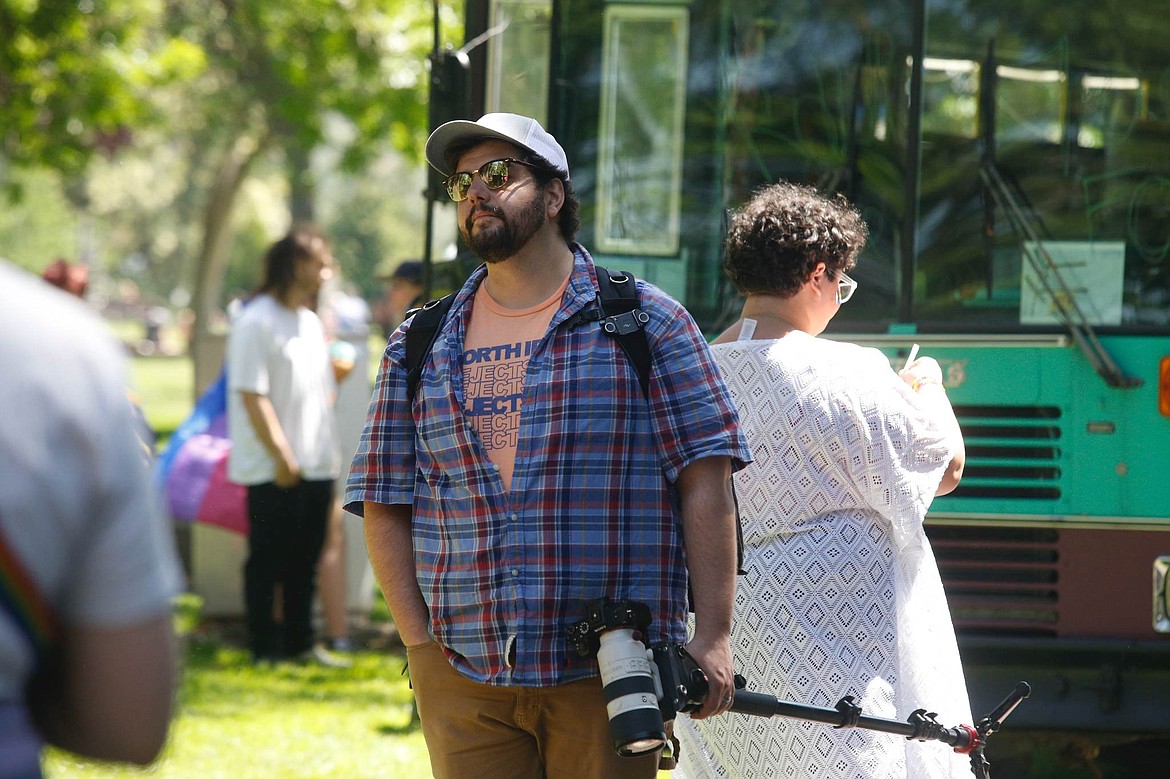 Dave Reilly holds a camera and watches people June 3, 2023 at Pride in the Park in Coeur d'Alene. The event, organized by the North Idaho Pride Alliance, was billed as a celebration of LGBTQ+ diversity. Reilly, who has a trail of documented antisemite and anti-gay social media posts and activities, was hired to do communications work for the Idaho Freedom Foundation.