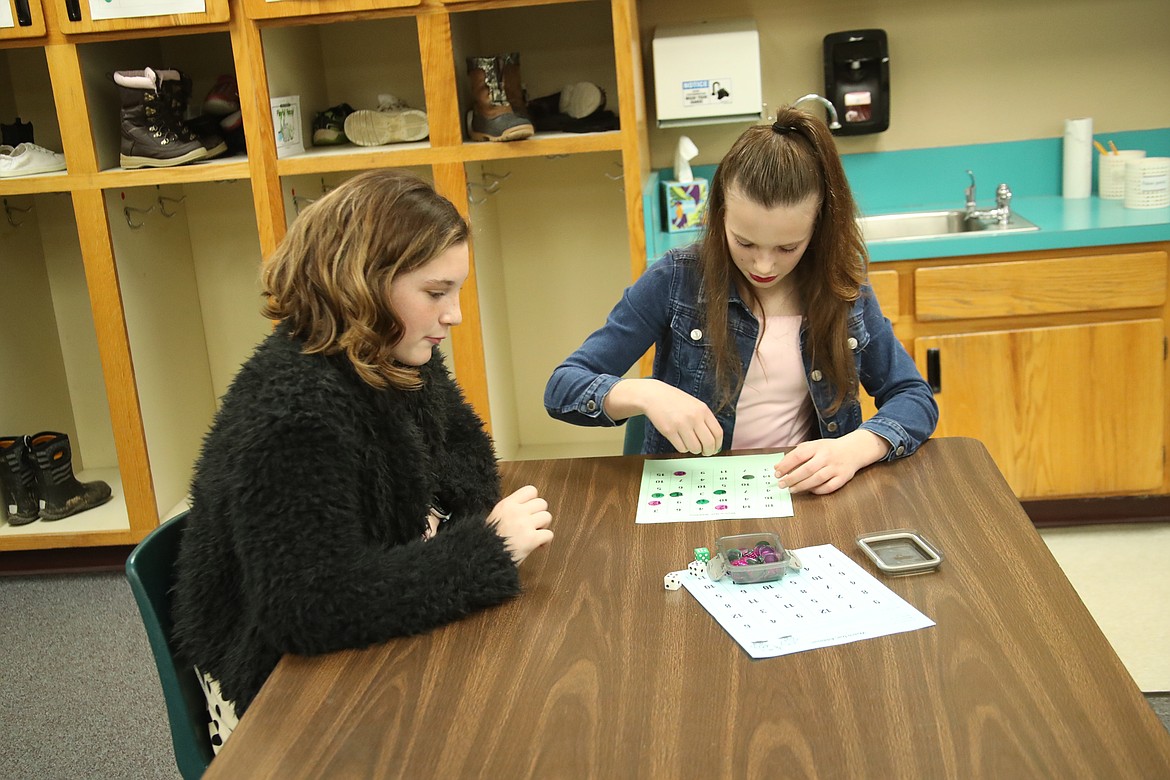 Grace Thompson and Kourtney Rogier play the math game Watch Out Addition at the recent Math Rocks! family fun night. Hope students, staff, and families played math games, enjoyed dinner, and had a lot of fun at the event.