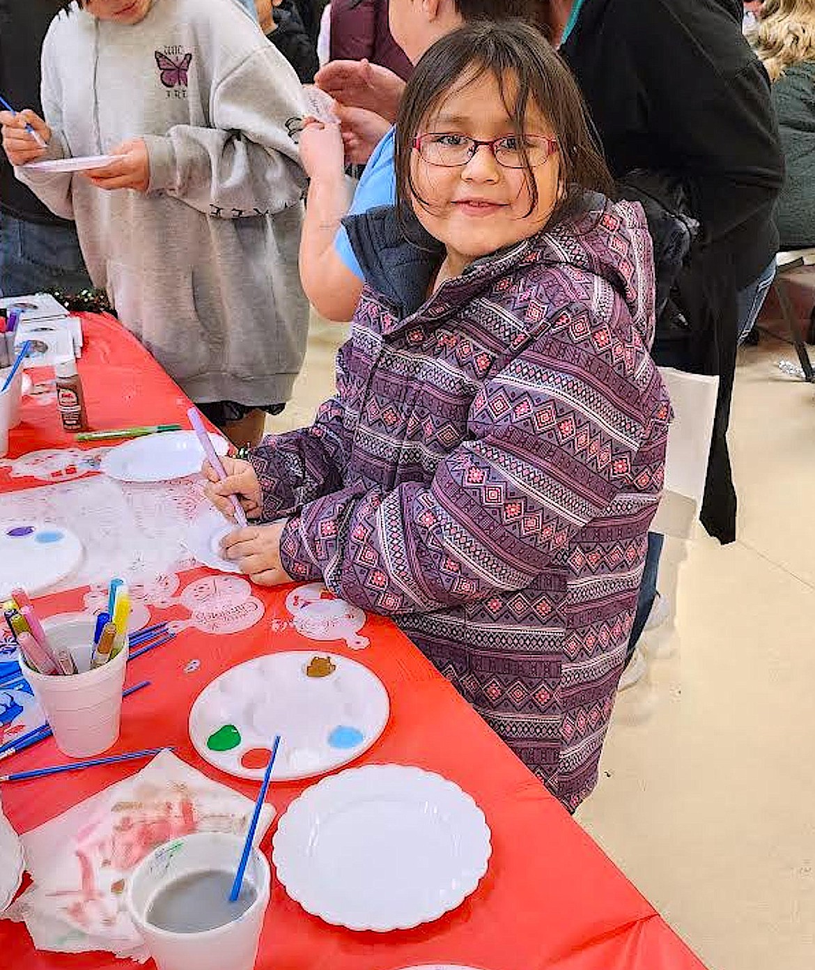 At the Busy Elves event, there were many family friendly crafts. This young lady is painting an ornament. (Berl tiskus/Leader)