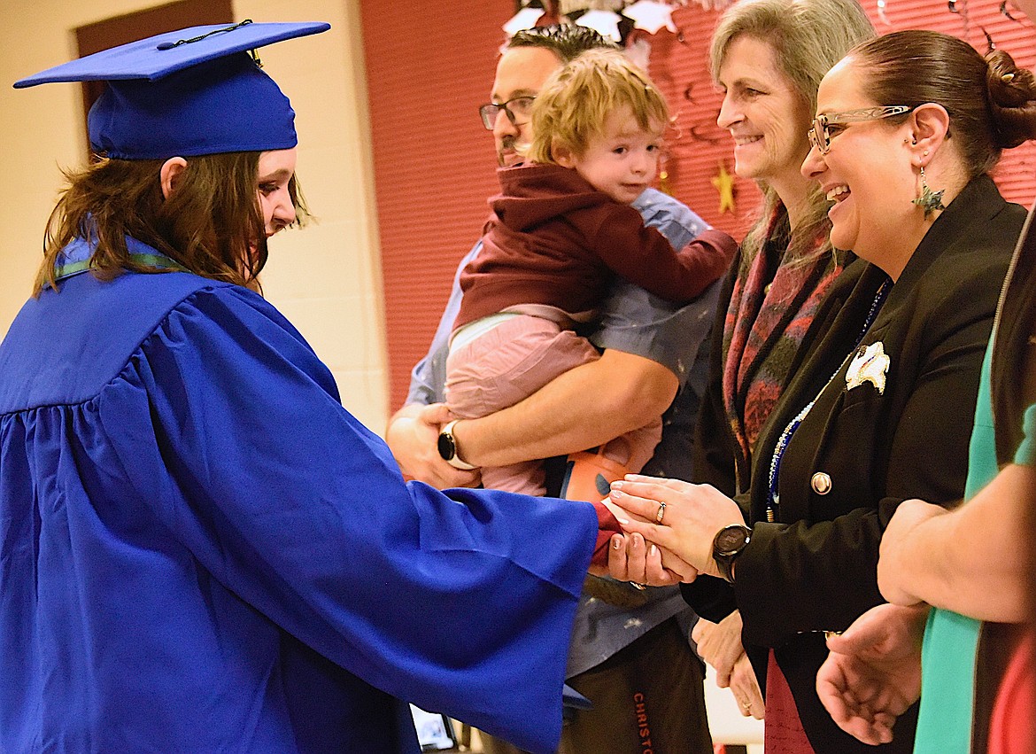 Graduate Lanie Lammers receives handshakes of congratulations fro dignitaries at summer and fall High School Equivalency graduation. (Berl Tiskus/Leader)