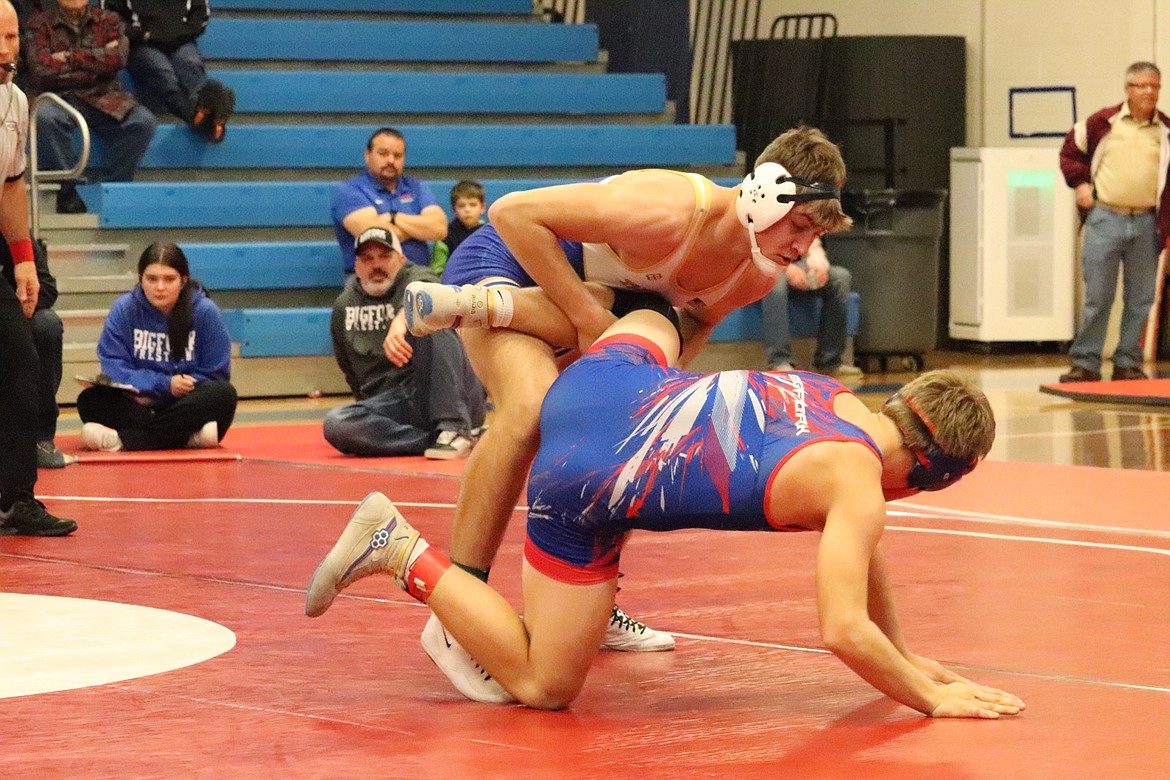 Thompson Falls Falls 182-pounder Max Hannum (blue and white) works on another opponent en route to winning the weight category title at this past weekend's Bob Kinney meet in Superior. (Photo by Kami Milender)