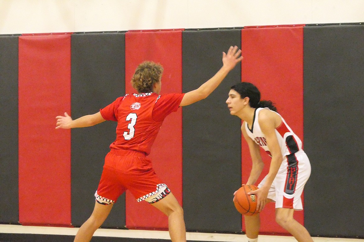 Hot Springs guard Elijah Campbell checks Arlee guard Ethan Fiddler during the Warriors win over the Savage Heat Saturday night in Hot Springs.  (Chuck Bandel/VP-MI)