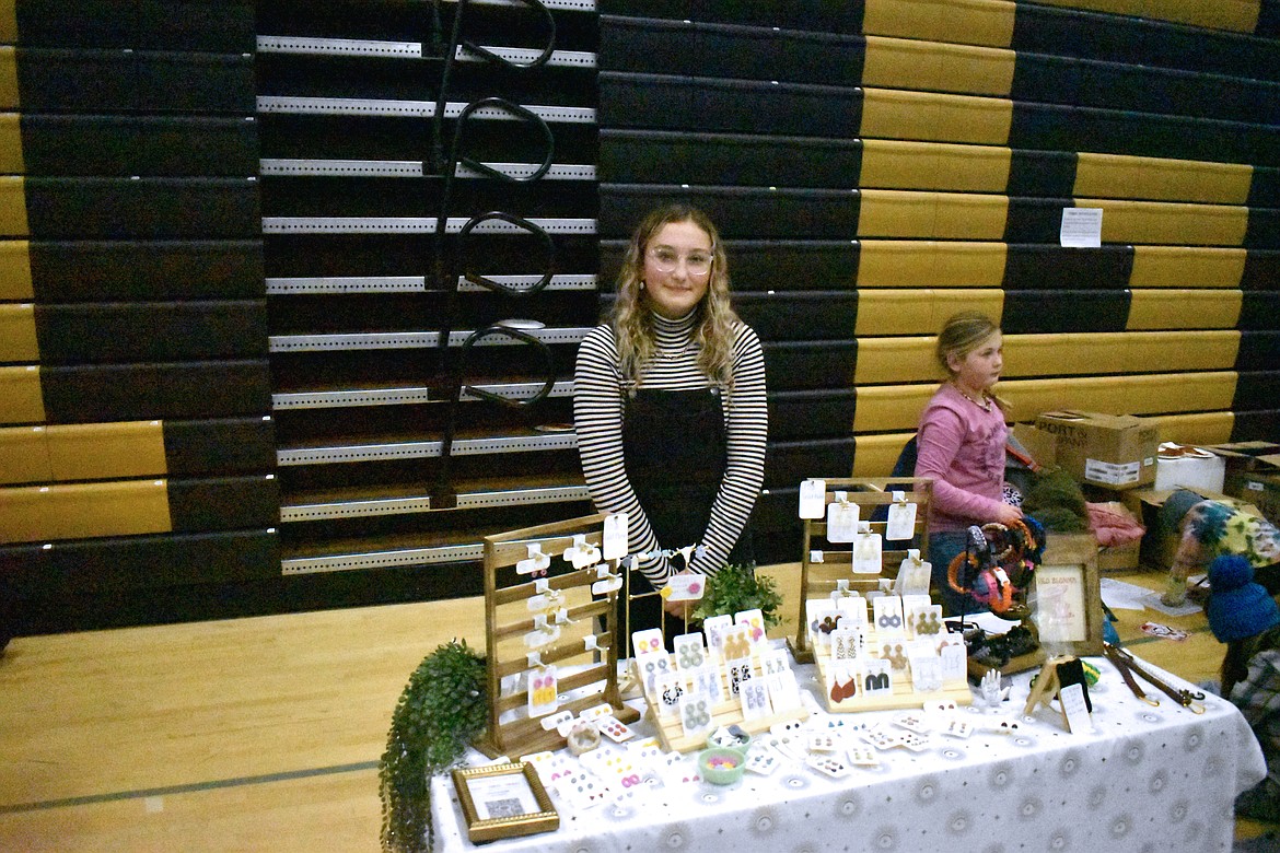 Fifteen-year-old Royal student Taylor Webb shows some of her handmade earrings at the Riyal Intermediate School bazaar Wednesday. Web has been making the jewelry since she was 12, she said.