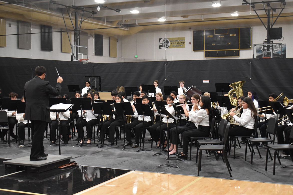 Music Teacher Erich Mietenkorte directs the Royal Middle School seventh-grade band in its first piece, “Defender of Time.”