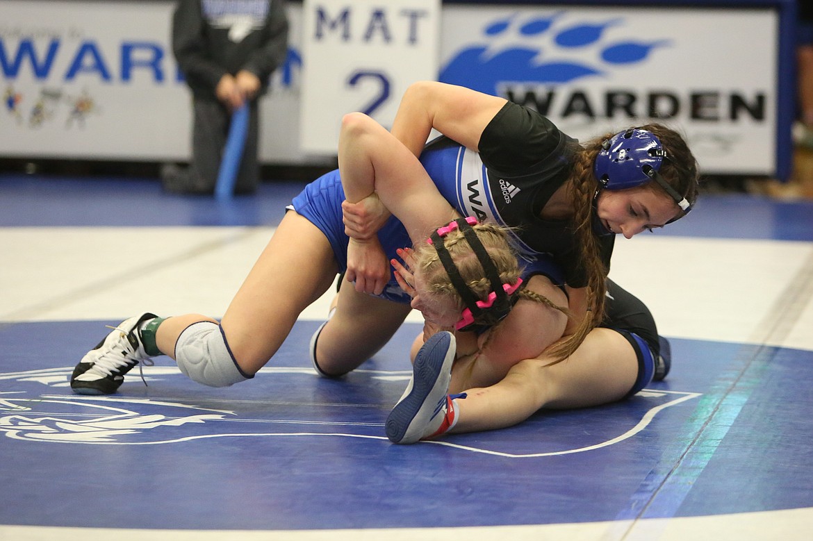 Warden senior Jada Hernandez, top, won the 120-pound bracket at the Warden Women’s Wrestling Invite on Saturday.