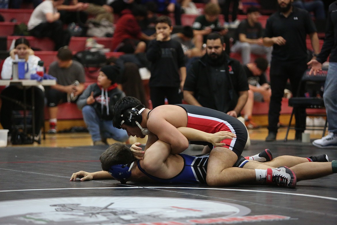 Othello junior Jeremiah Flores, top, wrestles at the Leonard Schutte Invitational on Saturday in Othello.