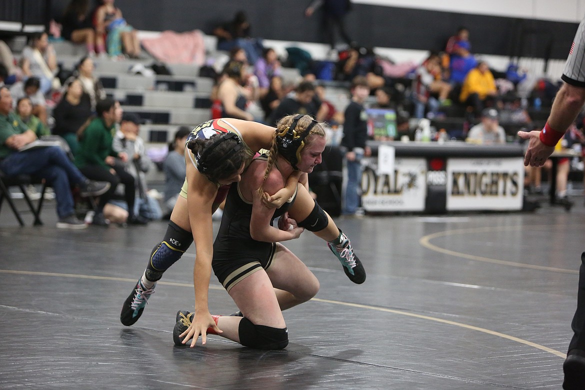 Royal senior Kiyra Terry, right, lifts up her opponent at the Lady Knights Invitational Saturday.