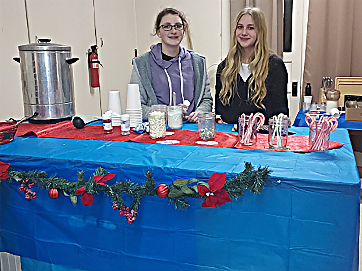 Area youngsters wait for customers seeking hot chocolate at last week's Christmas on Main Street in Priest River.