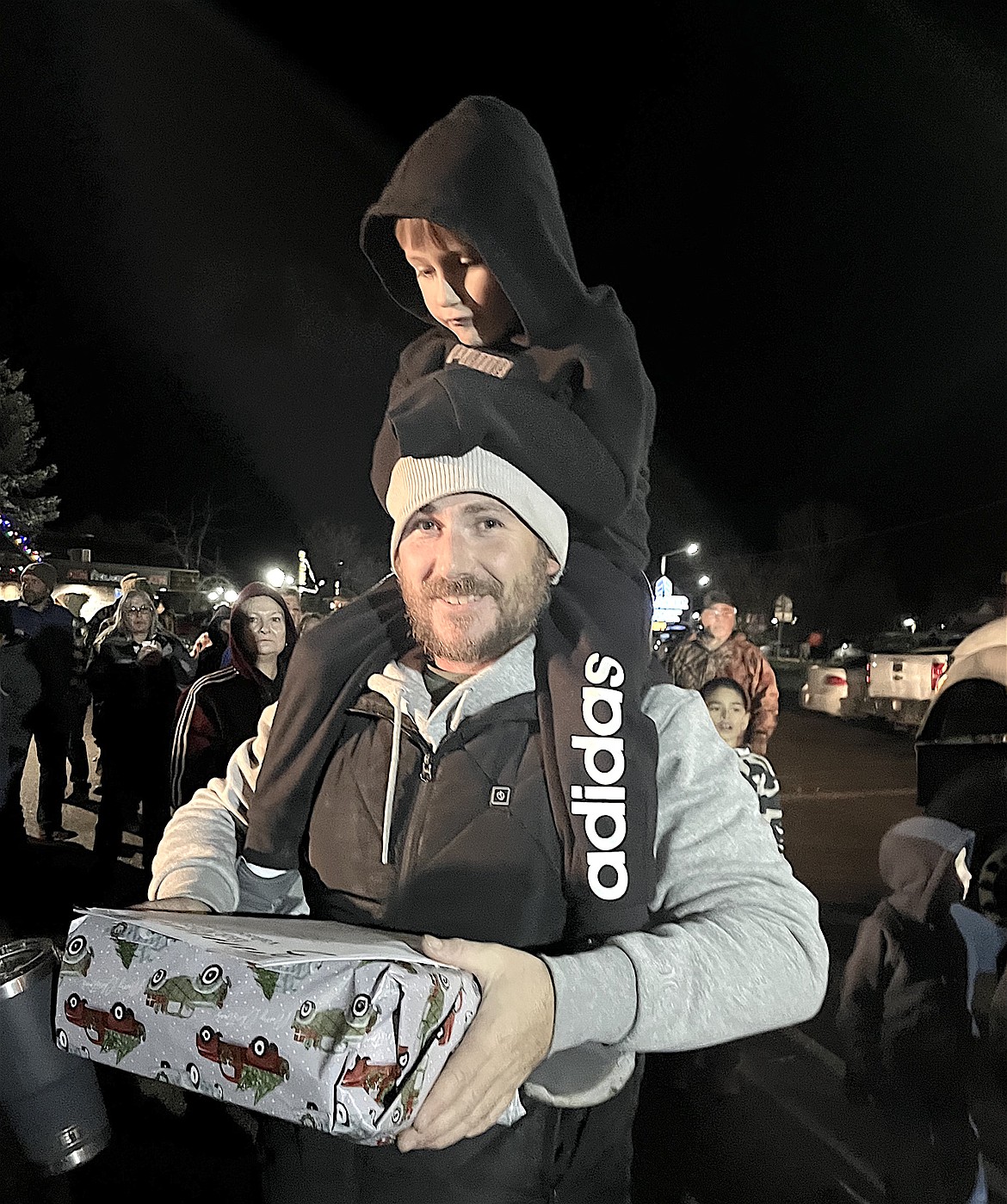 A pair of happy customers made off with one of 15 gift packages given away to ticket holders during the annual Holiday Treasures drawing, held last Friday night in Ronan and sponsored by the Chamber of Commerce. (Kristi Niemeyer/Leader)