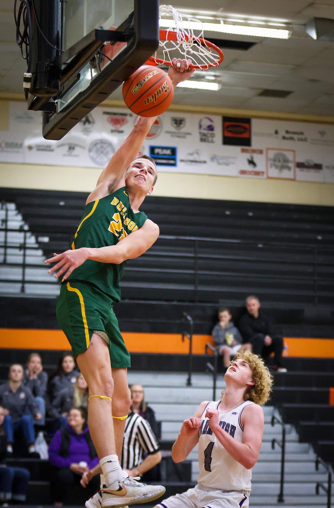 Carson Krack throws down a one-handed slam over Park’s Jon Durgan during action at the Western A Tip Off in Frenchtown Saturday. (Jeremy Weber/Bigfork Eagle)